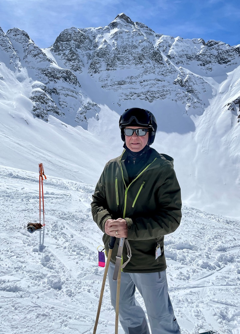 skier in gear with mountains behind